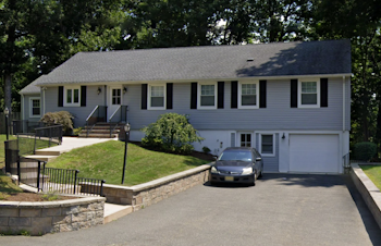 Exterior view of Chatham Group Home with a car parked in the driveway