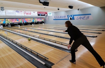 A person just bowled a bowling ball down a lane at a bowling alley.