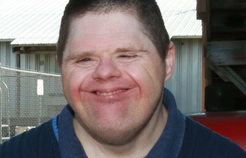 A closeup of a man smiling.