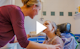 A video preview image, featuring a nurse assisting a young girl with washing her face.